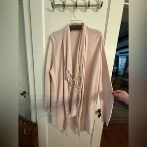 This cardigan is from the brand Repeat, which is a Swiss knitwear brand.